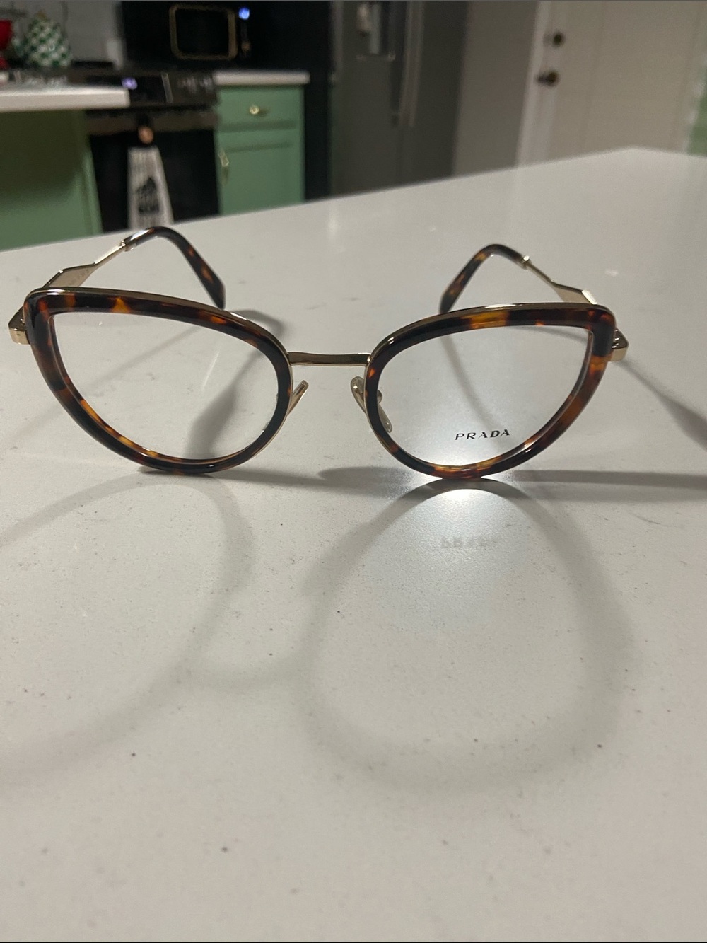 Prada Tortoiseshell Cat-Eye Glasses with Gold Trim